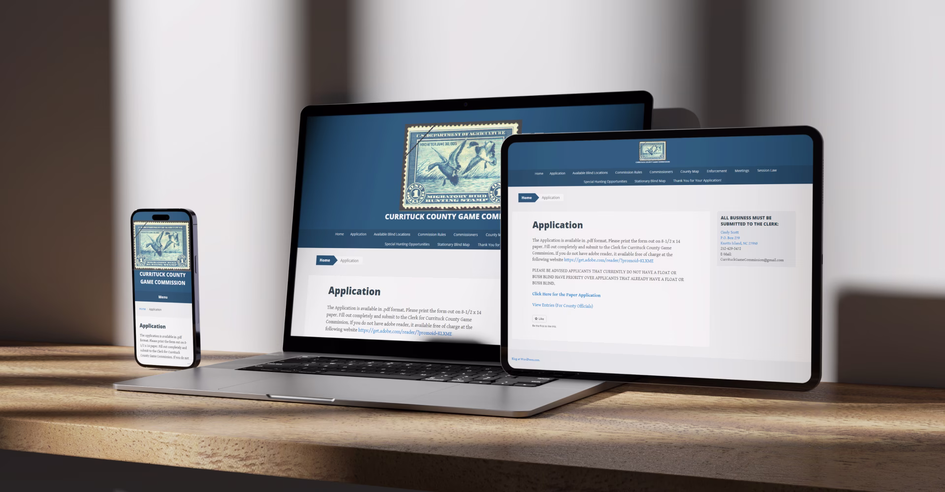 Currituck County Game Commission website displayed on laptop, tablet, and phone showing responsive design